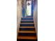 Stairs leading to the second floor with fresh paint and natural wood at 5673 Yorktown Rd, Douglasville, GA 30135