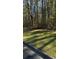 Wooded lot with grass and tall trees at Lot 15 Fairview Springs Dr, Ellenwood, GA 30284