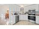 White kitchen with stainless steel appliances and view into dining area at 530 Brooksdale Dr, Woodstock, GA 30189