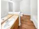 Clean bathroom with light oak vanity, neutral flooring, and a white bathtub at 7512 Rutgers Cir, Fairburn, GA 30213