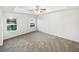 Spacious carpeted bedroom with large window and ceiling fan at 7512 Rutgers Cir, Fairburn, GA 30213