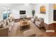 Virtually staged living room featuring hardwood floors, neutral decor, and ample natural light at 7512 Rutgers Cir, Fairburn, GA 30213