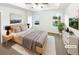 Virtually staged main bedroom with plush carpeting and natural light from large windows at 7512 Rutgers Cir, Fairburn, GA 30213