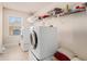 Bright laundry room, featuring washer, dryer, and ample shelving at 7691 Brazos Trl, Fairburn, GA 30213