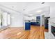 Kitchen and dining area with blue cabinets, hardwood floors, fireplace, and large window at 500 Meadowmeade Ln, Lawrenceville, GA 30043