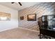 Home office features a brick accent wall, desk, and carpeted floor at 6280 Stillwood Ln, Cumming, GA 30041