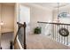 Upstairs hall with carpeted flooring and wooden railing at 6280 Stillwood Ln, Cumming, GA 30041