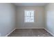 Simple bedroom with neutral walls, carpet, and a large window at 2196 Swallow Se Cir, Atlanta, GA 30315