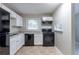 Modern kitchen with white cabinets, black appliances, and granite countertops at 2196 Swallow Se Cir, Atlanta, GA 30315