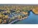 Lakefront community view with numerous homes and shoreline at 923 Pine Cir, Woodstock, GA 30189