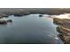 Aerial view of serene lake with wooded shoreline at 923 Pine Cir, Woodstock, GA 30189