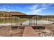 Private boat dock with covered area and wooden walkway at 923 Pine Cir, Woodstock, GA 30189