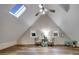 Spacious bonus room featuring skylights and wood-look flooring at 923 Pine Cir, Woodstock, GA 30189