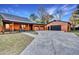 Log cabin home with a spacious driveway and detached garage at 923 Pine Cir, Woodstock, GA 30189