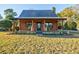 Front view of a charming log cabin home with a welcoming porch at 923 Pine Cir, Woodstock, GA 30189