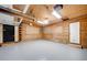 Spacious garage with overhead door and wood walls at 923 Pine Cir, Woodstock, GA 30189