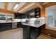 Modern kitchen with stainless steel appliances and dark cabinetry at 923 Pine Cir, Woodstock, GA 30189
