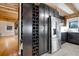 Wine storage and stainless steel refrigerator in a modern kitchen at 923 Pine Cir, Woodstock, GA 30189