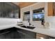White quartz countertops and farmhouse sink in a modern kitchen at 923 Pine Cir, Woodstock, GA 30189