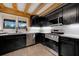 Modern kitchen with stainless steel appliances and dark cabinets at 923 Pine Cir, Woodstock, GA 30189