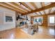 Living room features a stone fireplace, hardwood floors, and exposed wooden beams at 923 Pine Cir, Woodstock, GA 30189