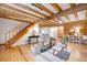 Spacious living room with exposed wooden beams, hardwood floors, and cozy seating area at 923 Pine Cir, Woodstock, GA 30189