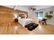 Main bedroom with hardwood floors, wood wall and ceiling fan at 923 Pine Cir, Woodstock, GA 30189