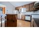 Galley kitchen with wood cabinets, island, and hardwood floors at 4771 Cool Springs Rd, Winston, GA 30187