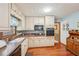 Kitchen with cream cabinets, black appliances and wood floors at 2036 Khyber Pass, Snellville, GA 30039