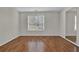 Well-lit bedroom featuring wood flooring and large window at 905 Leighs Brook Way, Dacula, GA 30019