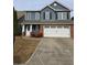 Charming two-story home with a blue and brick facade, white garage door, and landscaped front yard at 28 Samuel Nw Way, Cartersville, GA 30121