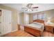 Bedroom features hardwood floors, ceiling fan and wood furniture at 291 Miquel Jorge Ln, Canton, GA 30115