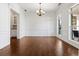 Elegant dining room with hardwood floors, white wainscoting, and a chandelier at 308 Norway Spruce Ct, Locust Grove, GA 30248