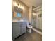 Updated bathroom with gray vanity, marble shower, and modern fixtures at 6700 Roswell Rd # 13B, Atlanta, GA 30328