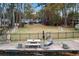 Landscaped backyard with seating area and lake access at 2440 Emerald Dr, Jonesboro, GA 30236
