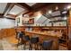 Elegant basement bar with wood finishes, seating, and a fireplace at 2440 Emerald Dr, Jonesboro, GA 30236