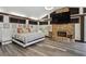 Spacious main bedroom with stone fireplace, large TV, and hardwood floors at 2440 Emerald Dr, Jonesboro, GA 30236