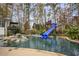 Resort-style pool with dual waterslides and rock landscaping at 2440 Emerald Dr, Jonesboro, GA 30236