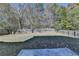 Fenced backyard with open grassy area and firepit at 3263 Star Pine Ct, Duluth, GA 30096