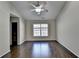 Bright bedroom with hardwood floors, a ceiling fan, and large window at 3263 Star Pine Ct, Duluth, GA 30096