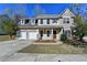 Two-story house with stone accents, three-car garage, and landscaped yard at 3263 Star Pine Ct, Duluth, GA 30096