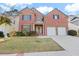 Brick two-story house with a two-car garage and manicured lawn at 727 Pear Grove Pl, Marietta, GA 30066