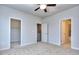 Spacious bedroom with carpet, ceiling fan, and access to closet and bathroom at 6150 Ripple Way # 75, South Fulton, GA 30349