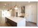 Modern kitchen with white cabinets, large island, and gold lighting at 260 Briscoe Way # 36, Alpharetta, GA 30009