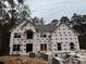 Two-story house under construction, gray roof, large windows, and brick facade at 990 Botanica Way, Fairburn, GA 30213