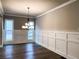 Formal dining room boasts hardwood floors and wainscoting at 11355 Bennett Ln, Johns Creek, GA 30097