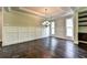 Spacious dining room with hardwood floors, wainscoting, and a chandelier at 11355 Bennett Ln, Johns Creek, GA 30097