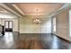 Bright dining room with hardwood floors and wainscoting, adjacent to the entry at 11355 Bennett Ln, Johns Creek, GA 30097