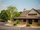 Stoney River Steakhouse and Grill building, with a brown metal roof and stone accents at 11355 Bennett Ln, Johns Creek, GA 30097