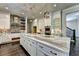 Elegant kitchen with white cabinets, marble island, and high-end appliances at 11355 Bennett Ln, Johns Creek, GA 30097